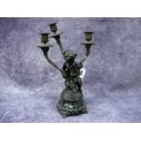 A Late XIX Century French Bronze and Ormolu Three Branch Candelabra, modelled as a cherub seated