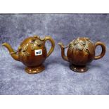 A Mid XIX Century Cadogan Teapot, decorated in a treacle brown glaze and moulded with flowers and