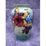 A Moorcroft Pottery Vase, of baluster form, painted in the Orchid pattern against a mottled green