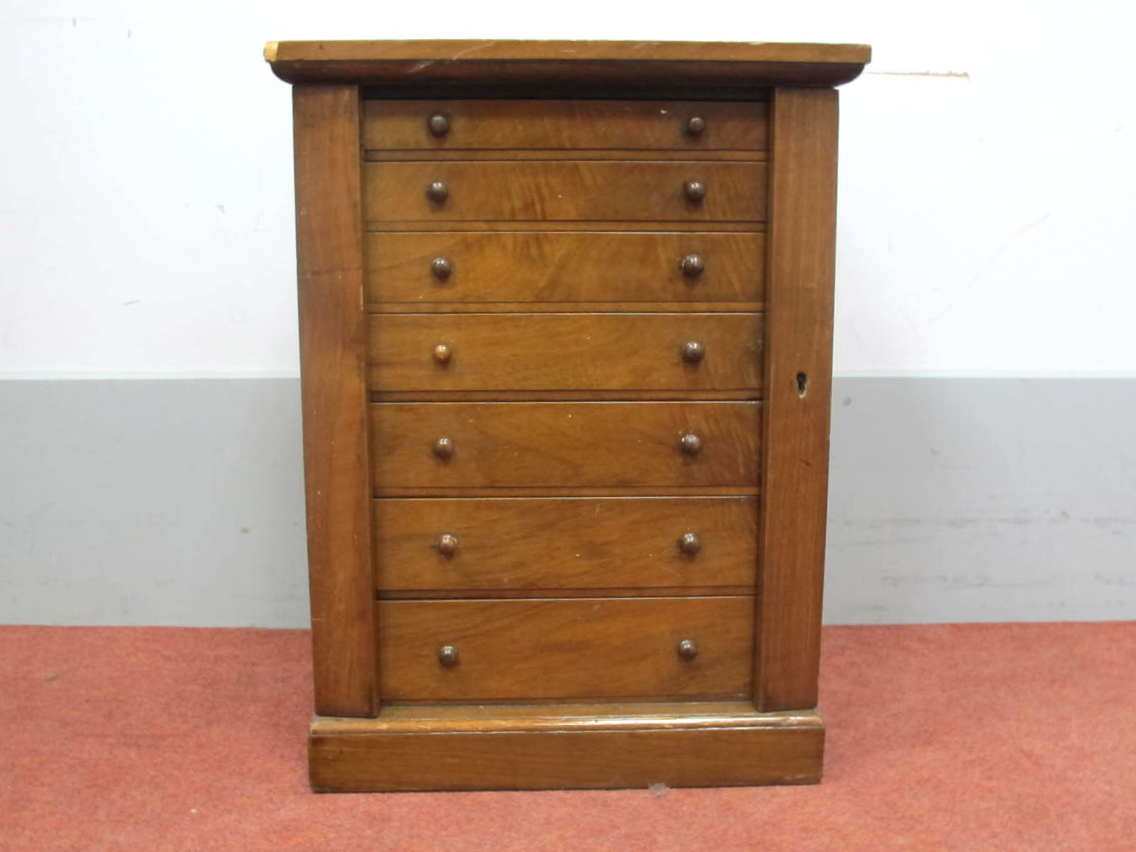 A Late XIX/Early XX Century Miniature Walnut Wellington Chest, with seven graduated drawers, side