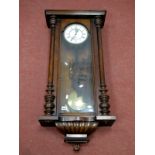 A Late XIX Century Vienna Wall Clock, in a walnut case, the white enamel dial with Roman numerals