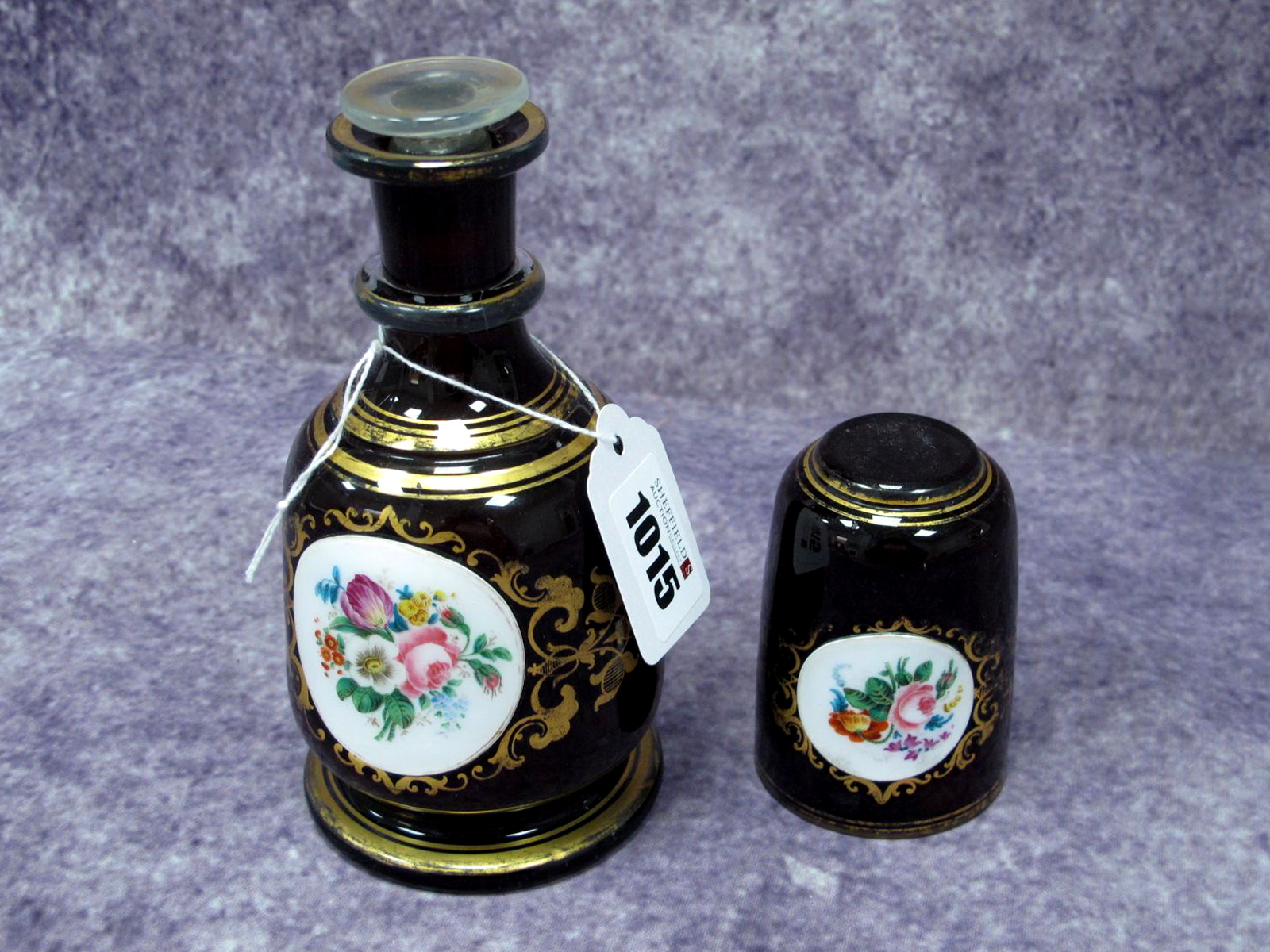 A Bohemian Late XIX Century Decanter and Matching Tumbler, the dark blue grounds each with white