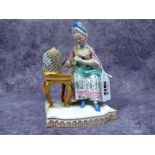 A Late XIX Century Meissen Style Porcelain Figure of a Seated Lady, with a bird in a cage beside