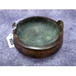 A Chinese Bronze Censer, of circular form with loop handles on tripod feet, reign mark to base, 13cm