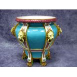 A Late XIX Century Majolica Pottery Jardiniére, of baluster form with lion mask ring handles and paw