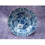 A Chinese Porcelain Saucer Dish, possibly Ming, painted in blue with flowers and a geometric