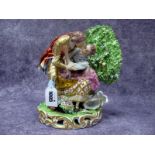 A Derby Porcelain Figure Group, modelled as a couple, she seated on a rock, a basket of flowers at