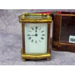 An Early XX Century French Brass Cased Carriage Clock, the white enamel dial with black Roman