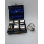 Five Hallmarked Silver Napkin Rings, (various makers / dates), together with an EPNS example; all