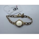 A 9ct Gold Cased Ladies Wristwatch, to integral openwork bracelet with 9ct gold clasp.