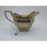 A Hallmarked Silver Jug, JG, Birmingham 1907, of panelled form with wide spout, raised on four bun