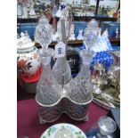 Three Bottle Glass Decanter Set, in plated triform stand with pierced bottle supports, 40cm high.