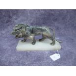 A Mineral Figure of a Roaring Lion, (tail damage), approximately 23cm long, with alabaster base.