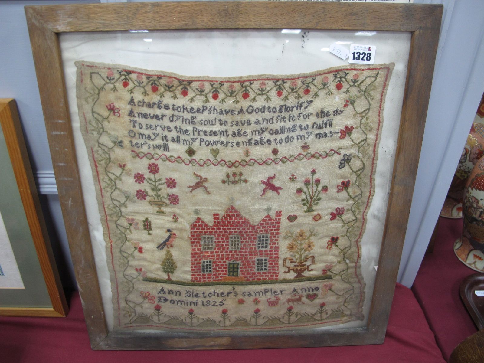 A Sampler by Ann Bletcher, 1825 hand worked with verse, birds, house and foliage, framed 18 x 40cm.