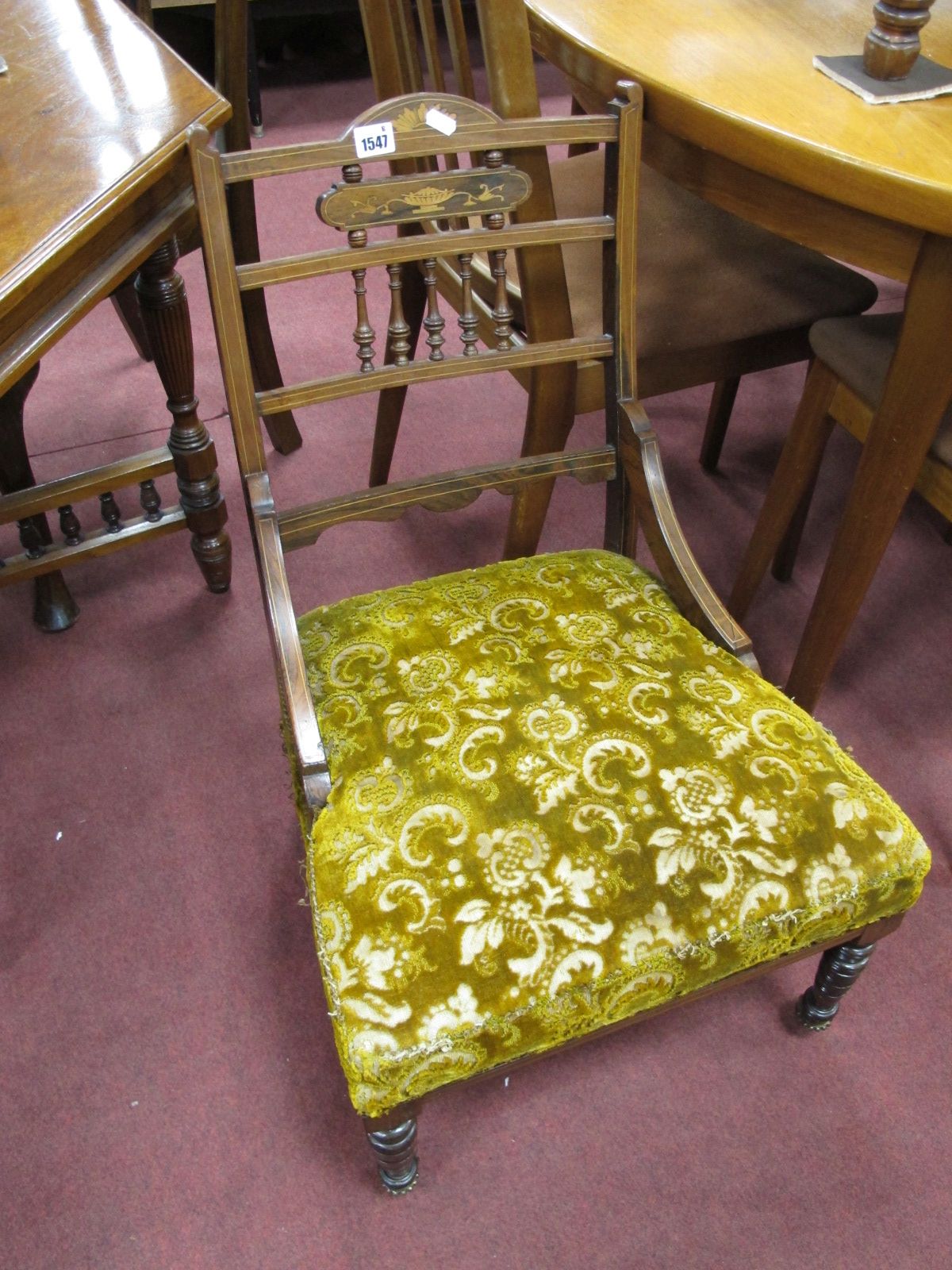 An Early XX Century Rosewood Inlaid Nursing Chair, with turned spindles, upholstered seat, on turned