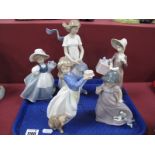 Lladro Figurine of a Lady with Present, 20cm high, four Nao figurines. (5)