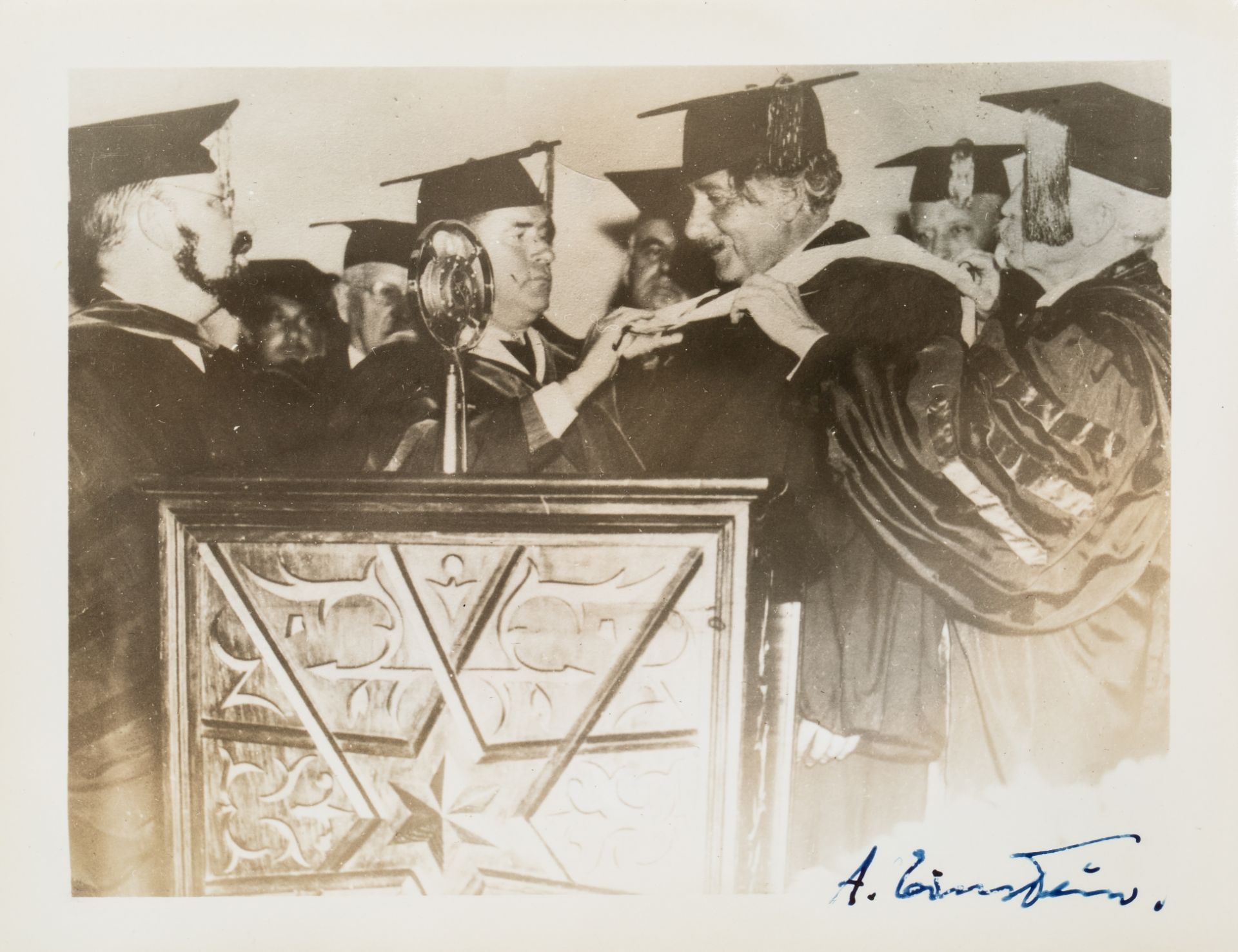 [EINSTEIN] A SIGNED PHOTOGRAPH OF EINSTEIN RECEIVING AN HONORARY DIPLOMA FROM YESHIVA UNIVERSITY, NE