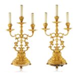 A PAIR OF BRONZE THREE-LIGHT ELECTRIFIED CANDELABRAS
