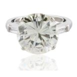 A 7.36 CT ROUND BRILLIANT AND TRAPEZOID DIAMOND RING