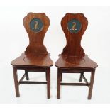 PAIR OF GEORGE III PERIOD ARMORIAL HALL CHAIRS