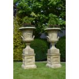 PAIR OF MOULDED STONE URNS