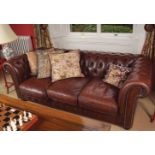 DEEP BUTTONED HIDE UPHOLSTERED ROLL BACK SETTEE