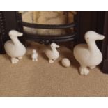 GROUP OF 4 UNGLAZED CERAMIC DUCKS