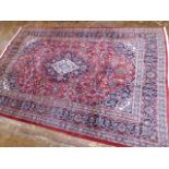 Red ground persian mashad floral medallion design carpet (2.97m x 1.97m)