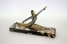 AN ART DECO FIGURE France circa 1920 Cast metal with face and hands made of erinoid.