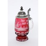 A BEER STEIN Colourless glass with ruby red overlay and cut forest landscape. Pewter