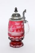 A BEER STEIN Colourless glass with ruby red overlay and cut forest landscape. Pewter