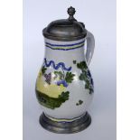 A FAIENCE JUG probably Schrezheim. Pear shape with polychrome painting and pewter lid.