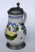 A FAIENCE JUG probably Schrezheim. Pear shape with polychrome painting and pewter lid.