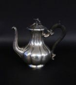 A COFFEE POT France circa 1900 Silver. Baroque form with ebonized wooden handle.