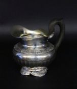 A CREAM JUG German, 19th century Silver, 13 lot. Gilt interior, ebonized wooden handle.