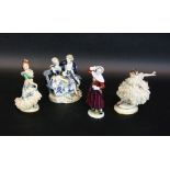 FOUR PORCELAIN FIGURES Volkstedt, 20th century Painted in colour, some with lace tulle.