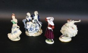 FOUR PORCELAIN FIGURES Volkstedt, 20th century Painted in colour, some with lace tulle.