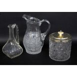 THREE GLASS ITEMS Crystal carafe, juice jug and biscuit box with metal lid and knob made