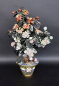 A JEWELLERY TREE China Small tree with leaves and flowers cut from gemstones in a brass