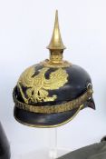 A PRUSSIAN SPIKED HELMET circa 1900 Leather with brass. In original hat box and protective