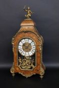 A DECORATIVE BOULLE CLOCK circa 1970 In Louis XV style. Wooden case with brass ornaments.