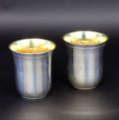 A PAIR OF CUPS Silver 800. With gilt interior. Approximately 121 grams, 7.5 cm high.