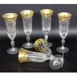 A SET OF 6 EXQUISITE CHAMPAGNE FLUTES Cut crystal glass with gold rim and hunting motifs.
