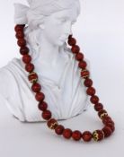 HALSKETTE MIT KORALLENKUGELN. D.12mm. l.48cm  A NECKLACE WITH CORAL BEADS Diameter 12 mm. 48 cm