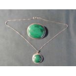 A large pin Brooch, oval form with Malachite set into a white metal mount with gadrooned edge, 6.5cm