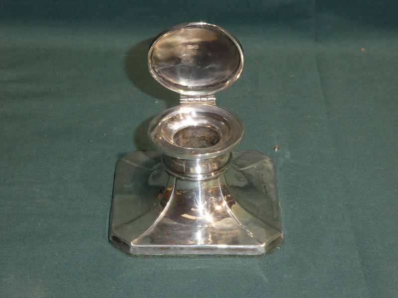 A mid century silver Capstan Ink Well, square canted form, hinged circular cover, glass well not