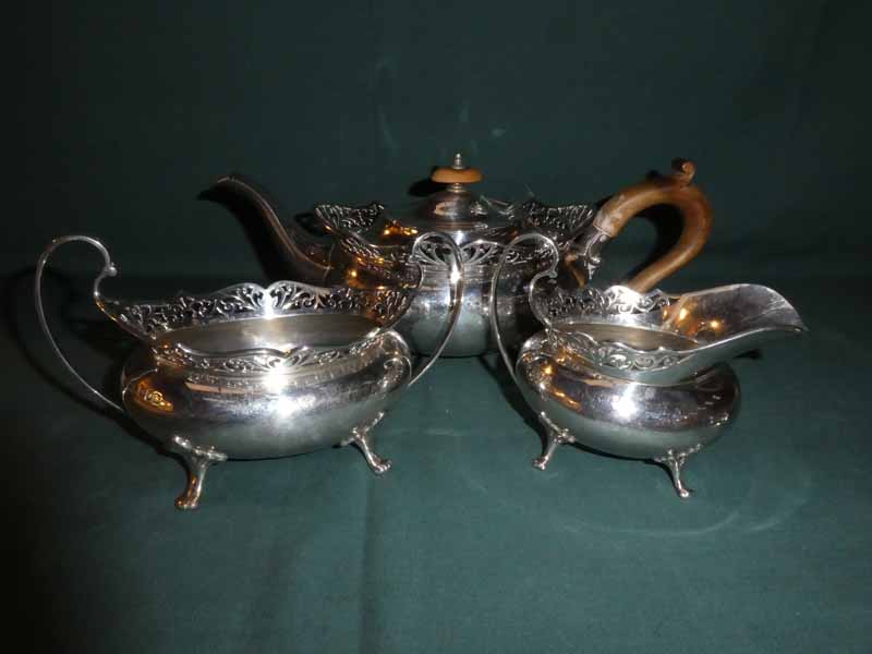 An early 20th century silver Three Piece Tea Service, oval form with pierced rim, open top sucrier