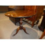 A Georgian oak circular tip top Breakfast/Supper Table on turned tripod support