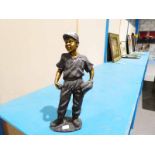 A bronze patinated cast metal model of a Baseball Player, 20' high