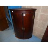 A Georgian mahogany bow front two door Wall Hanging Cabinet